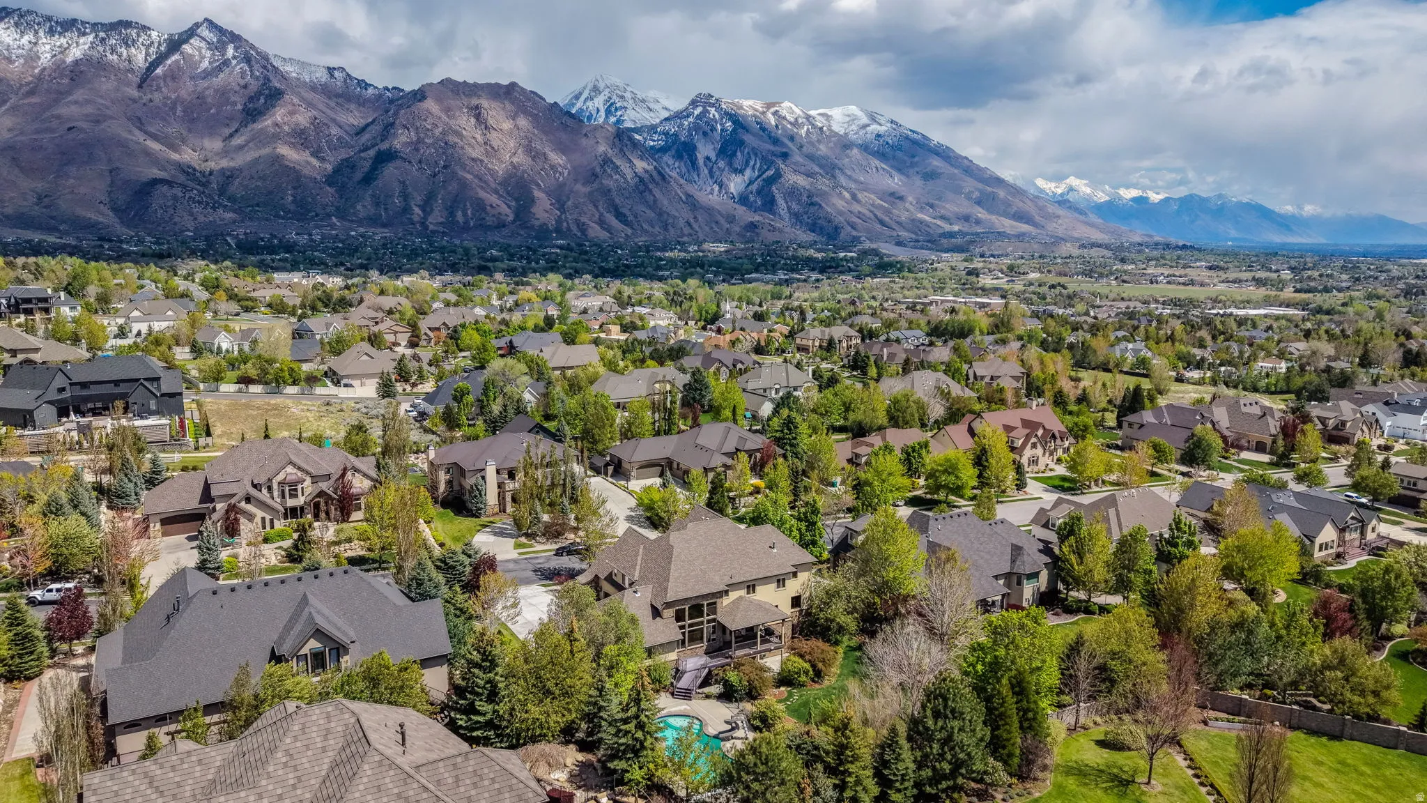 Aerial perspective of suburban area with a mountainous background