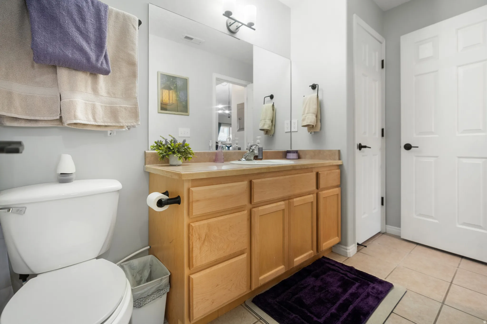 Bathroom featuring vanity and light tile patterned floors