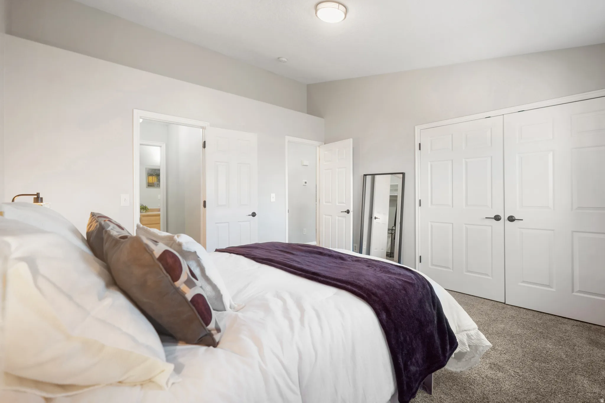 Bedroom featuring carpet flooring and a closet