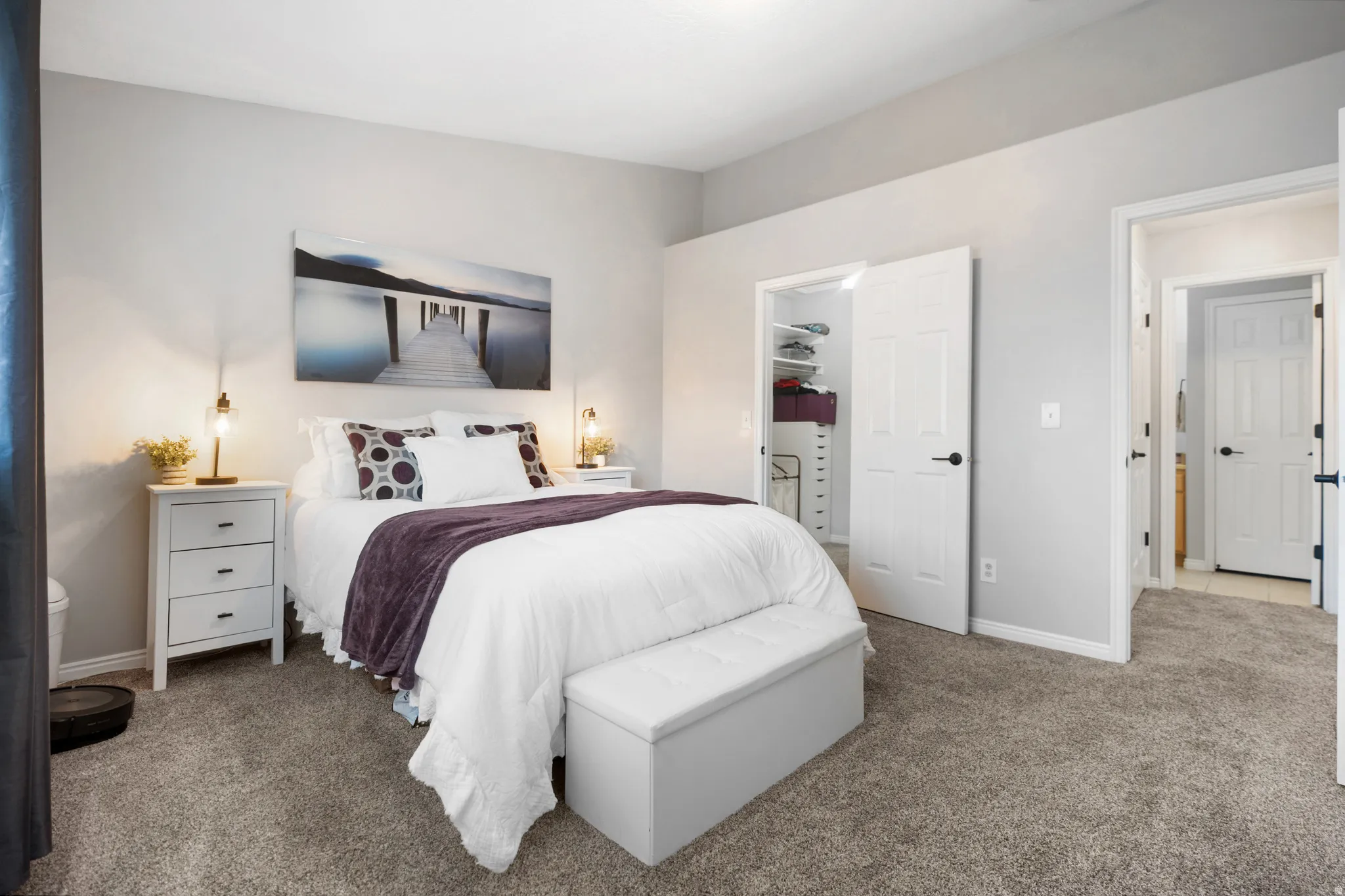 Carpeted bedroom with a spacious closet and baseboards