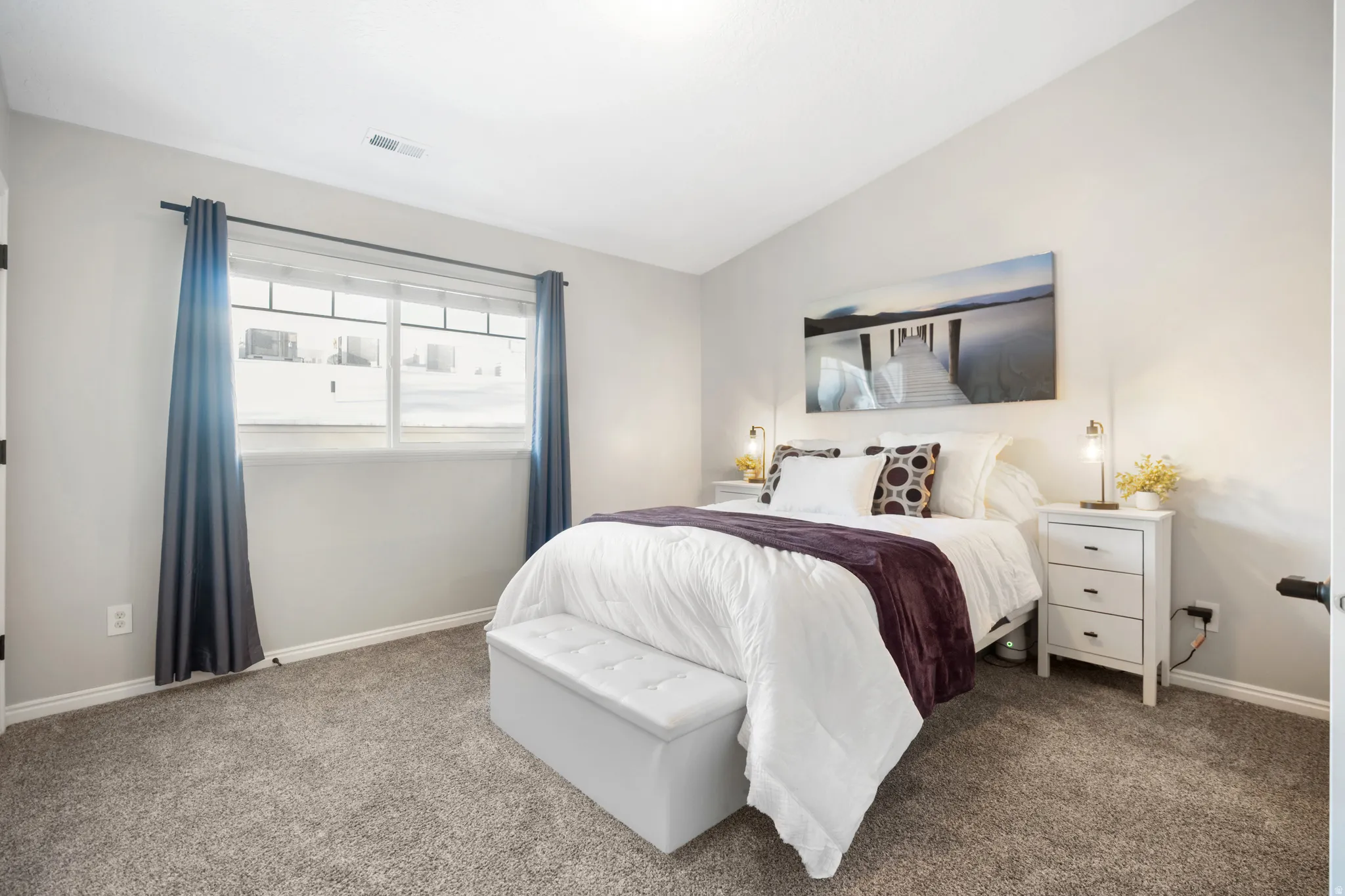 Bedroom with vaulted ceiling and carpet flooring