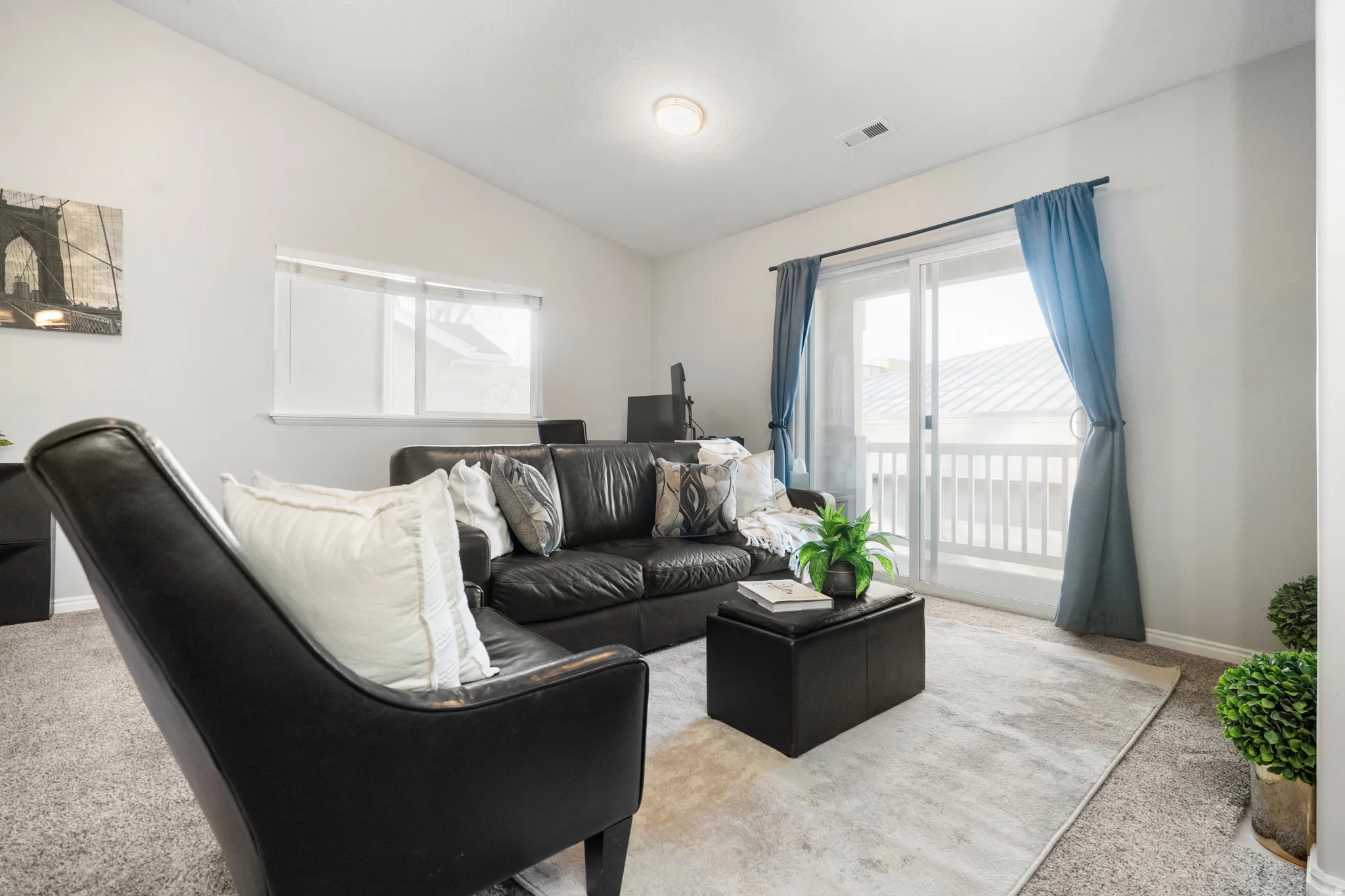 Carpeted living room with baseboards and lofted ceiling