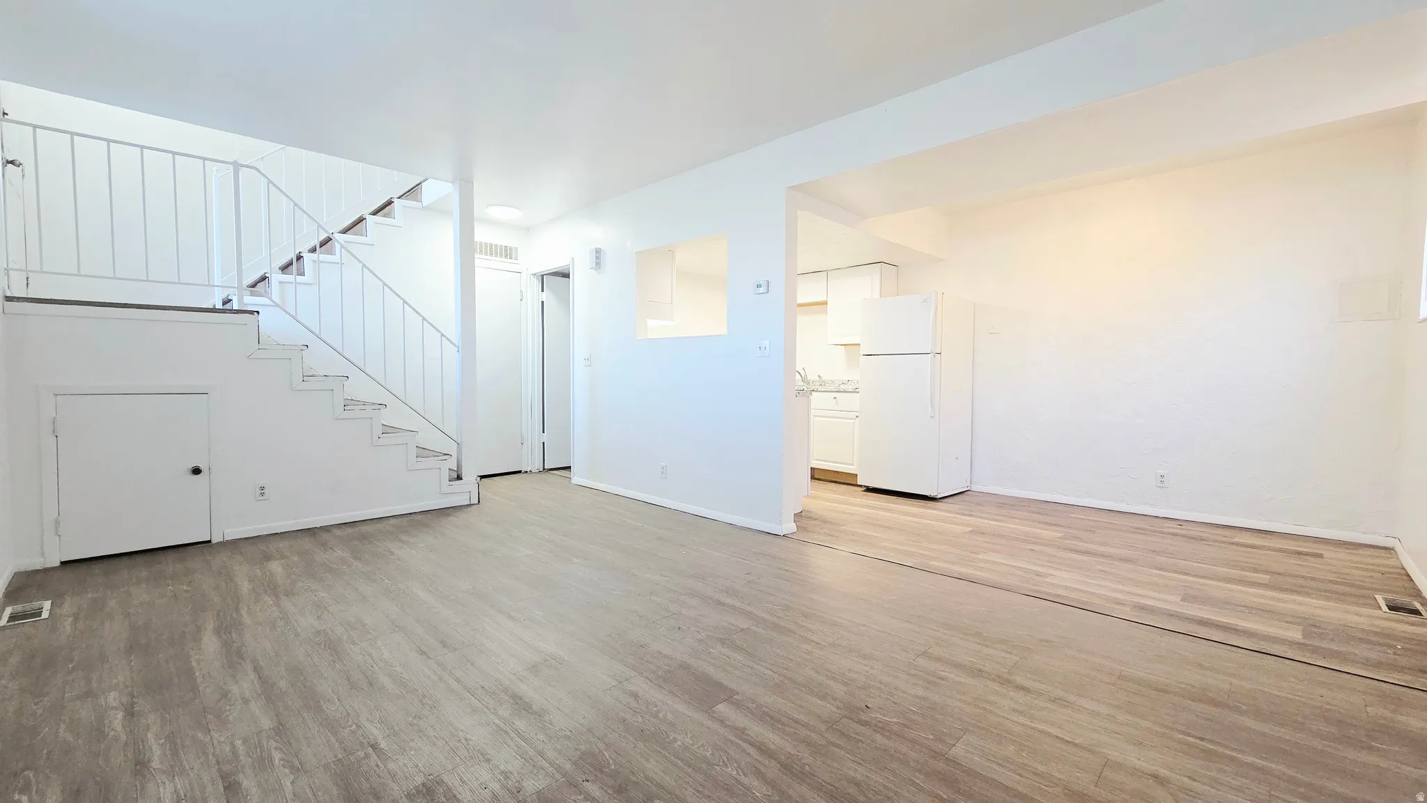 Unfurnished living room with light wood-style floors