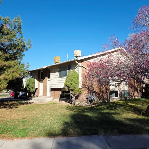 View of front facade with brick siding and a front lawn