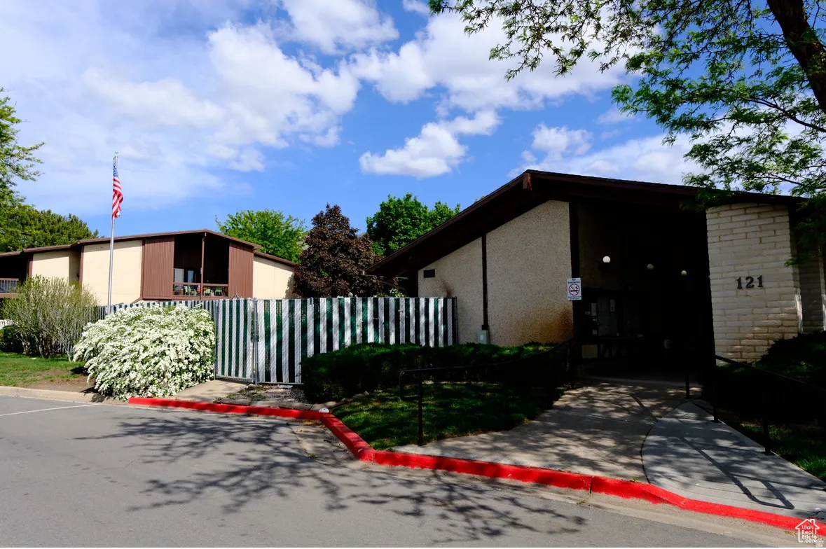 View of side of home featuring a gate