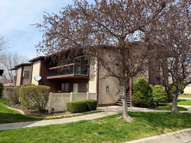 View of front of house with stairway and a balcony