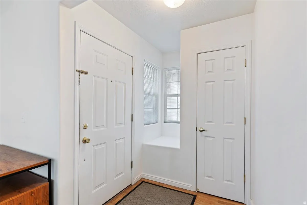 Entrance foyer featuring light wood finished floors and a textured ceiling