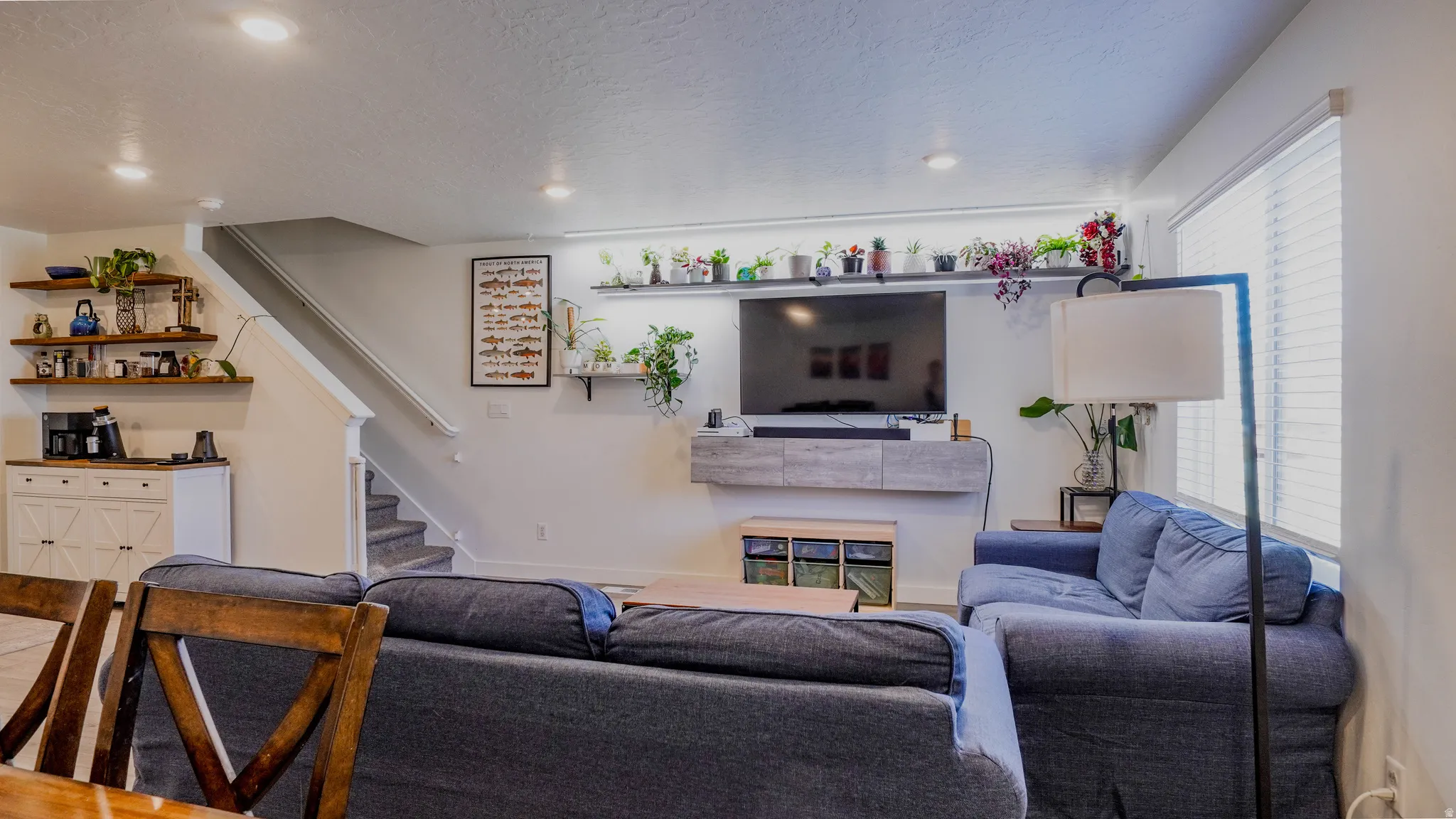 Living room featuring recessed lighting and a textured ceiling