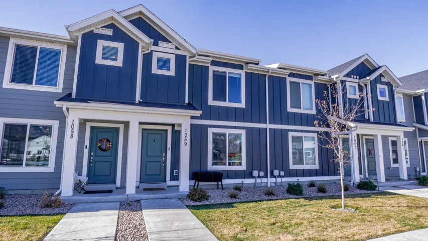 View of front of house featuring board and batten siding and a front lawn