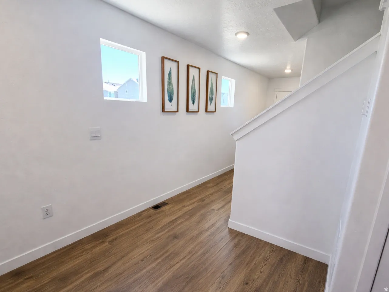 Hall featuring baseboards and dark wood finished floors