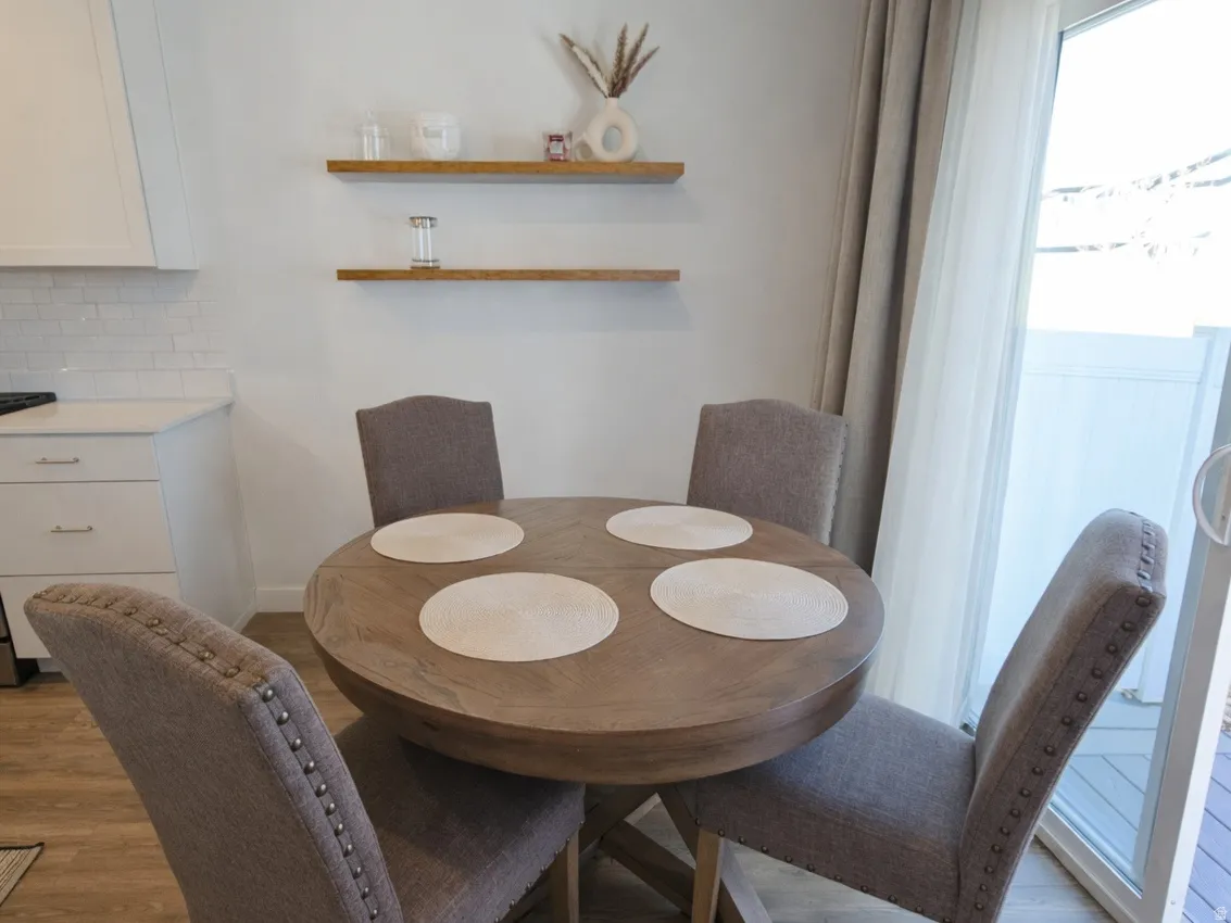 Dining room with light wood-style flooring and baseboards