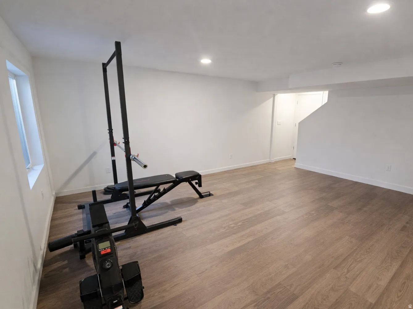 Exercise room featuring wood finished floors and recessed lighting