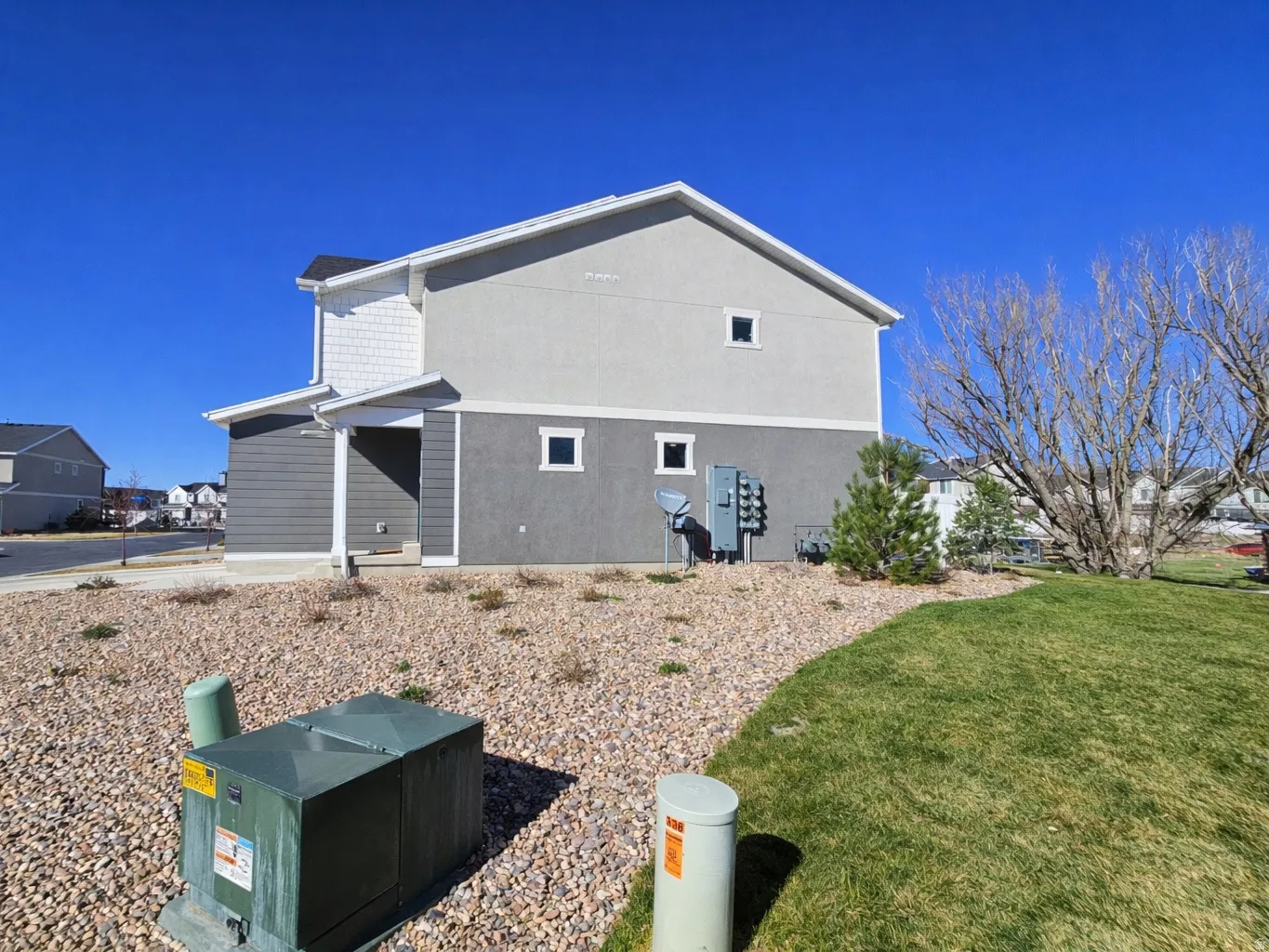 View of property exterior featuring a yard and stucco siding
