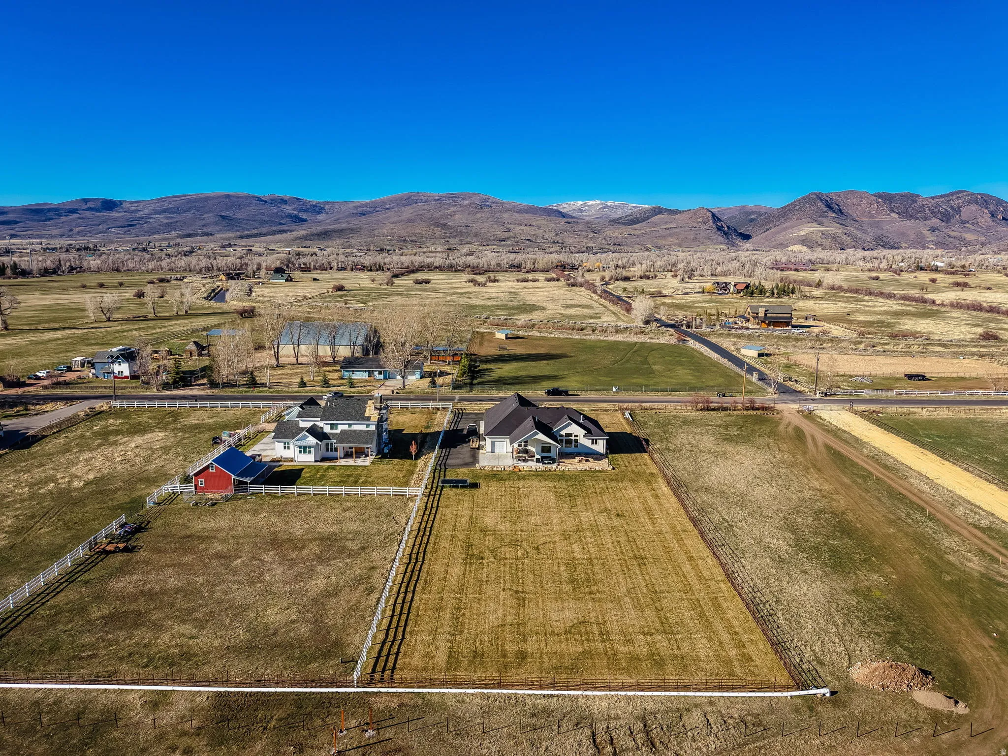 Aerial overview of property's location with rural landscape and a mountain backdrop