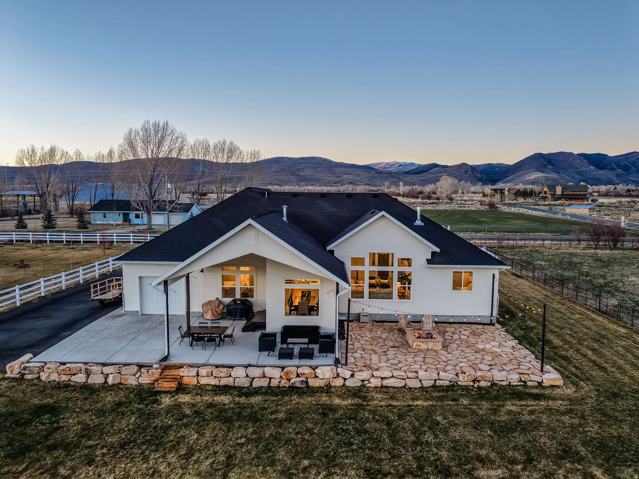 Rear view of house featuring a fenced backyard, a patio area, a garage, and a mountain view