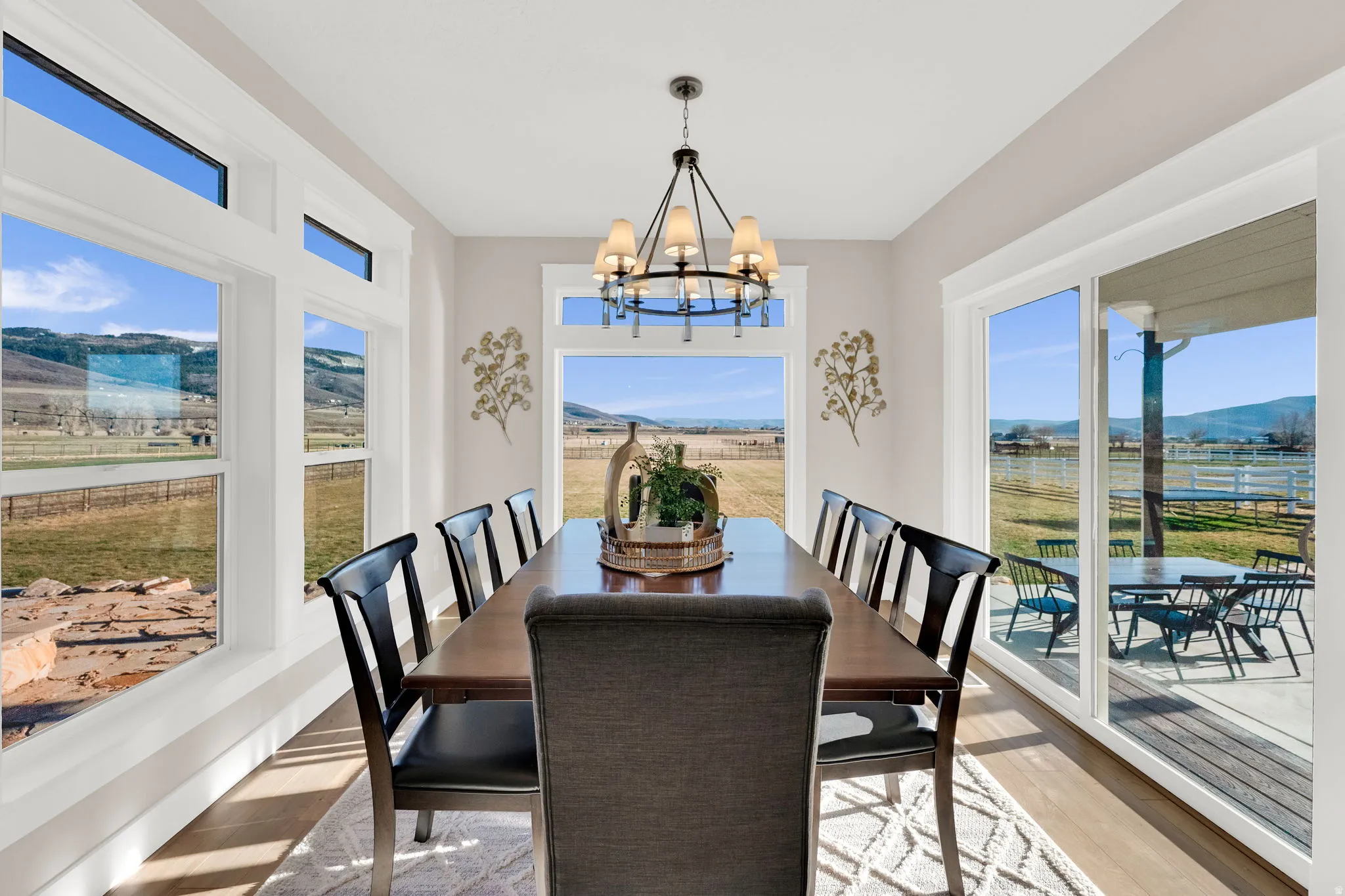 Dining space with a mountain view, light wood-type flooring, a chandelier, and plenty of natural light