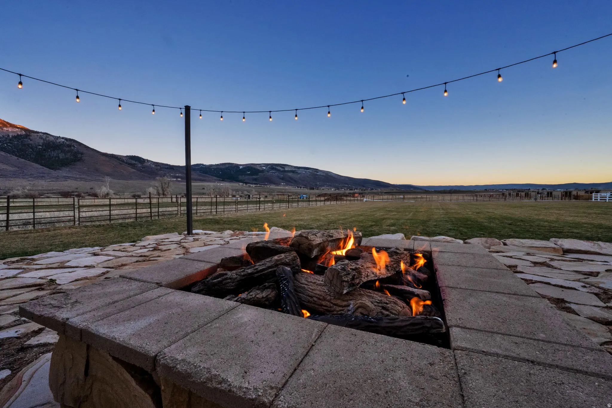 Patio terrace at dusk featuring a mountain view, a patio, and a fire pit