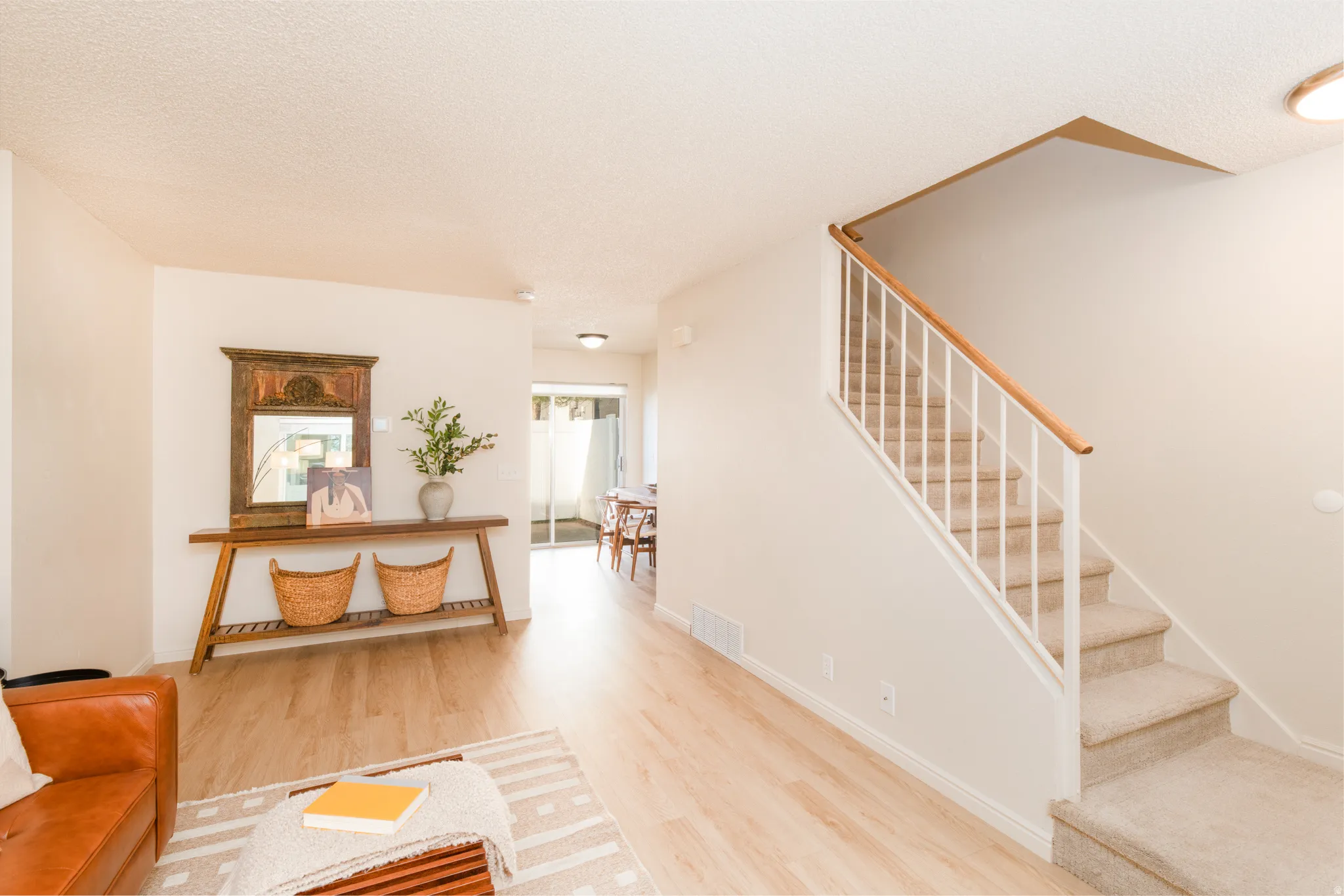 Staircase with wood looking floors.