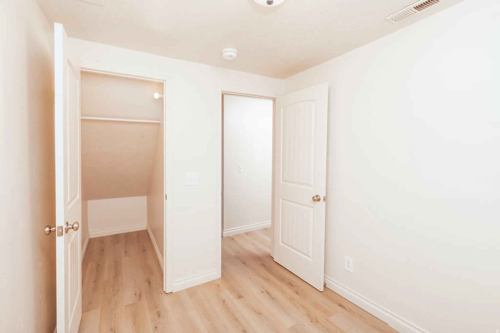 Den / office featuring light wood looking floors.