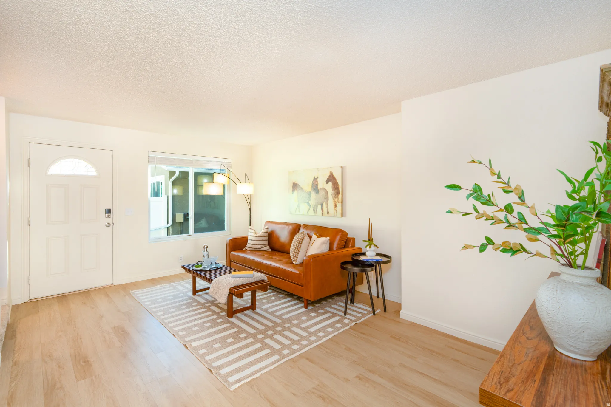 Living room with light wood looking floors.