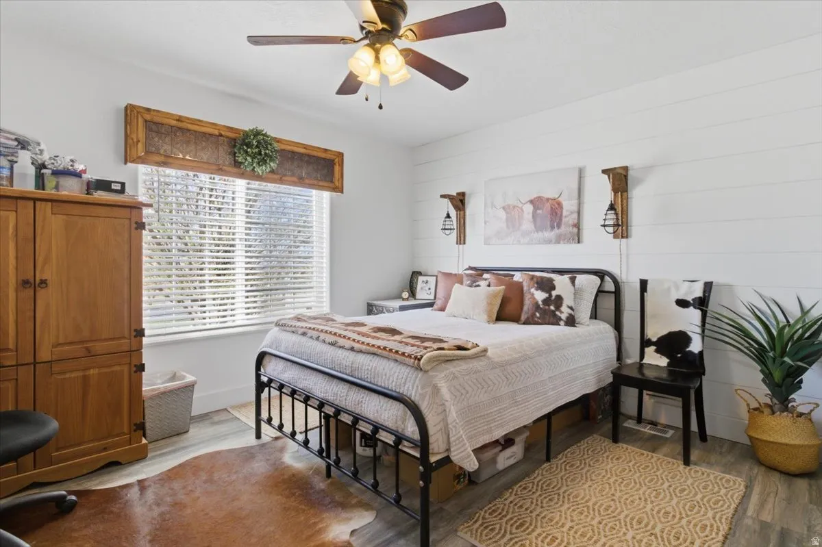 Bedroom featuring wood finished floors and ceiling fan