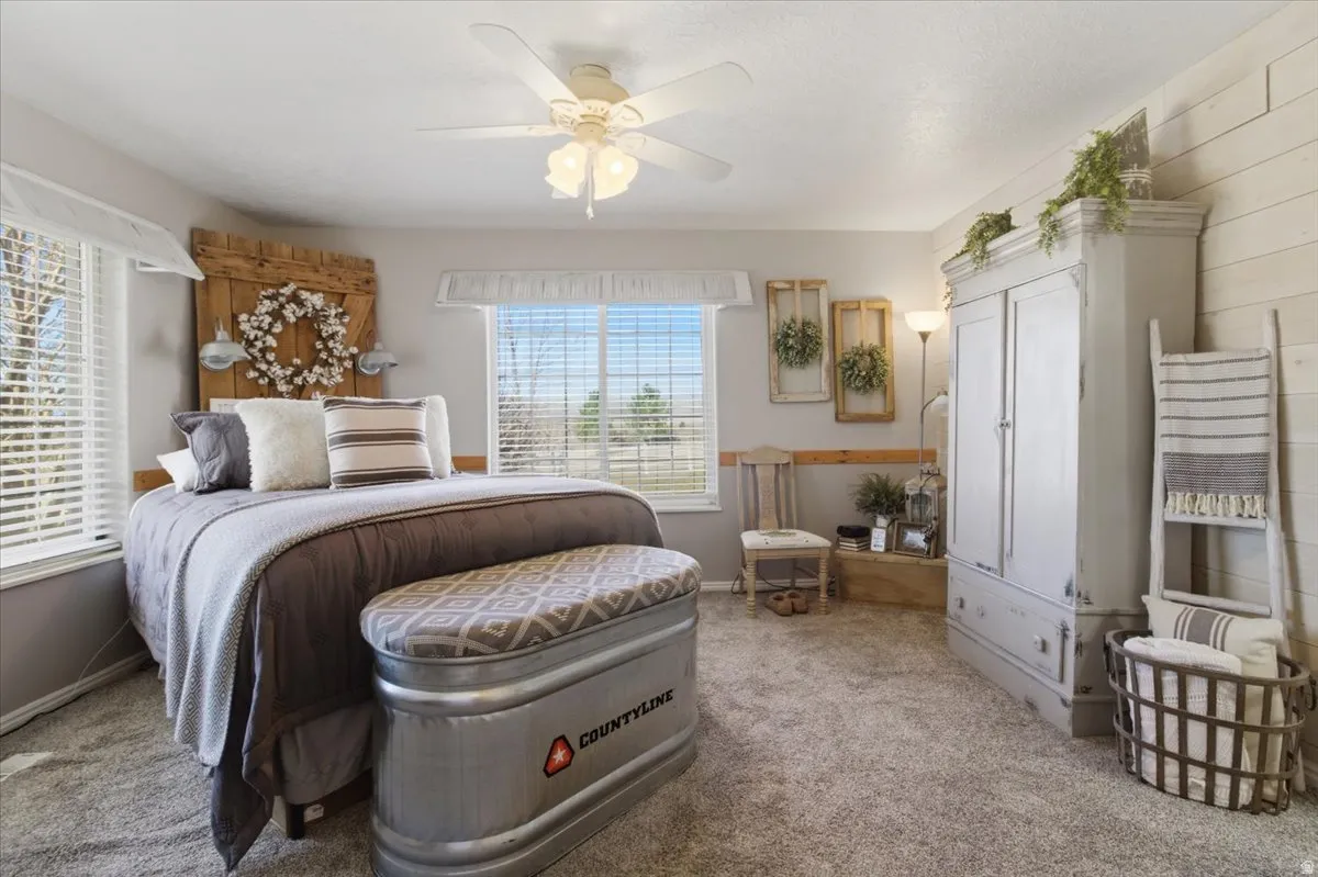 Bedroom with light carpet and ceiling fan