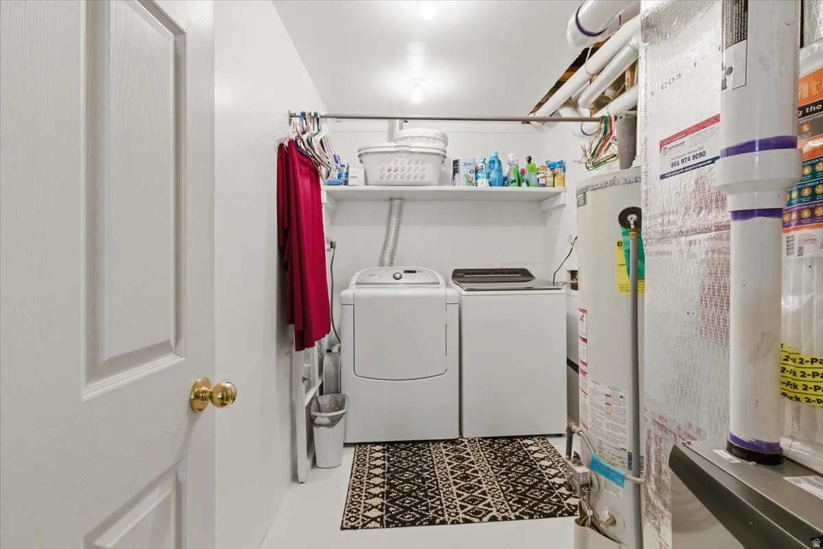 Laundry area with water heater and washer and dryer