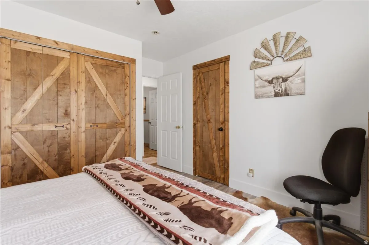 Bedroom featuring a closet, ceiling fan, and wood finished floors