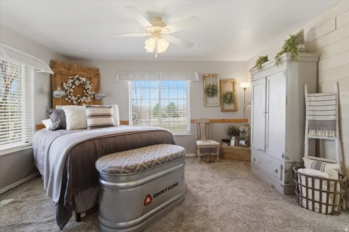 Bedroom with light carpet and ceiling fan