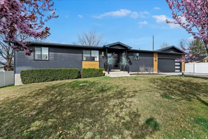 View of front of property featuring an attached garage and driveway
