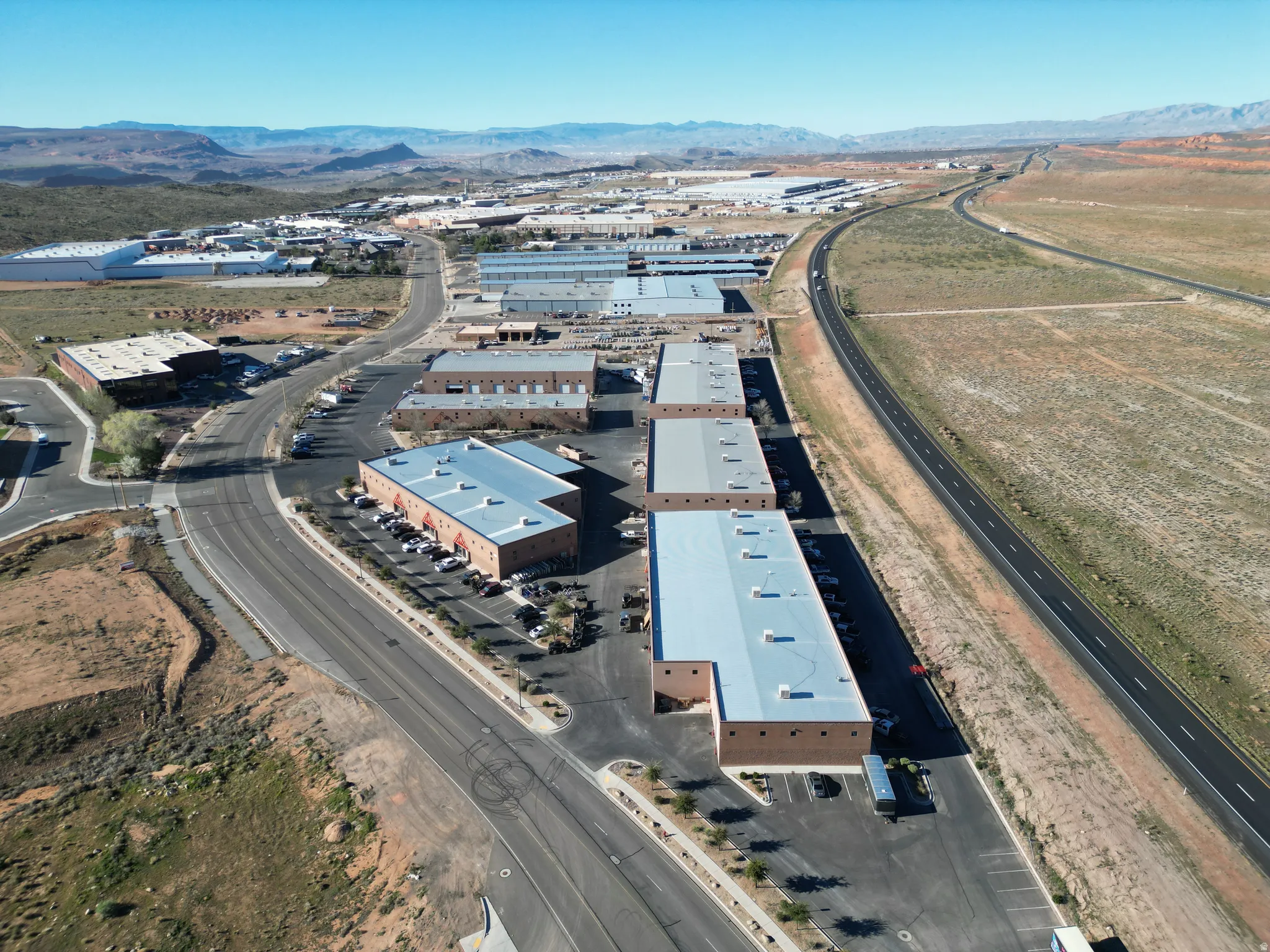 Aerial overview of property's location featuring a mountainous background