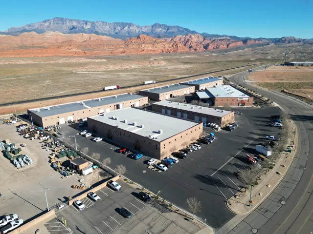 Aerial view of a mountain backdrop and a commercial area