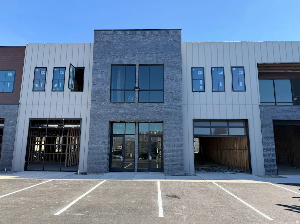 View of building exterior featuring uncovered parking