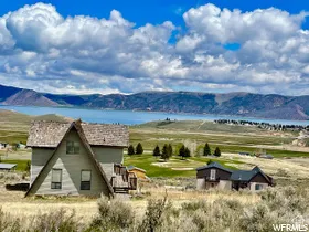 View of mountain background with rural landscape and a nearby body of water