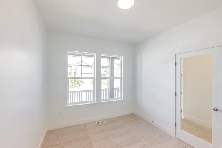 Neutral interior with light beige carpeting and white walls