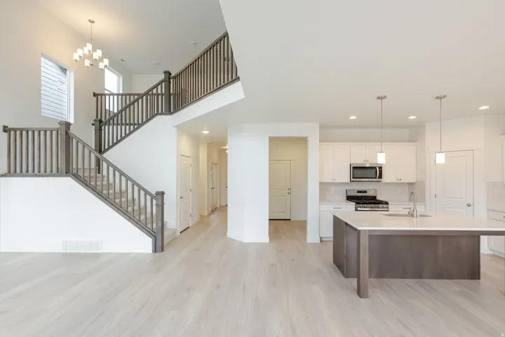Open-concept living space with light wood-finish flooring