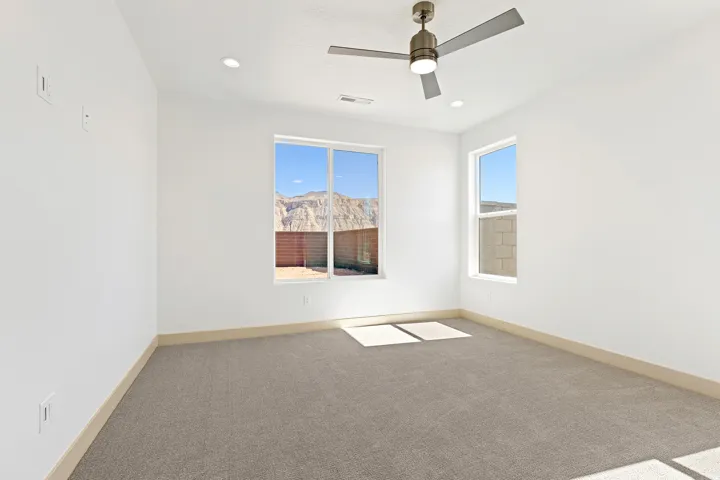 Spare room with carpet flooring, a ceiling fan, and recessed lighting