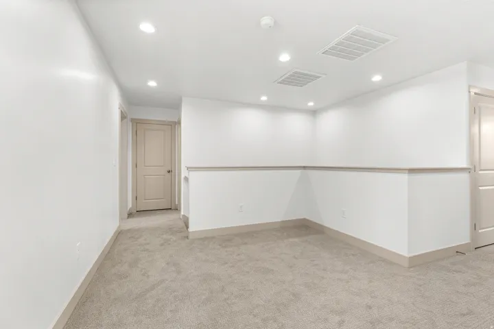 Unfurnished room featuring light colored carpet and recessed lighting