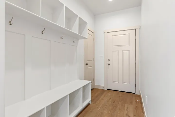 Mudroom featuring light wood finished floors and baseboards