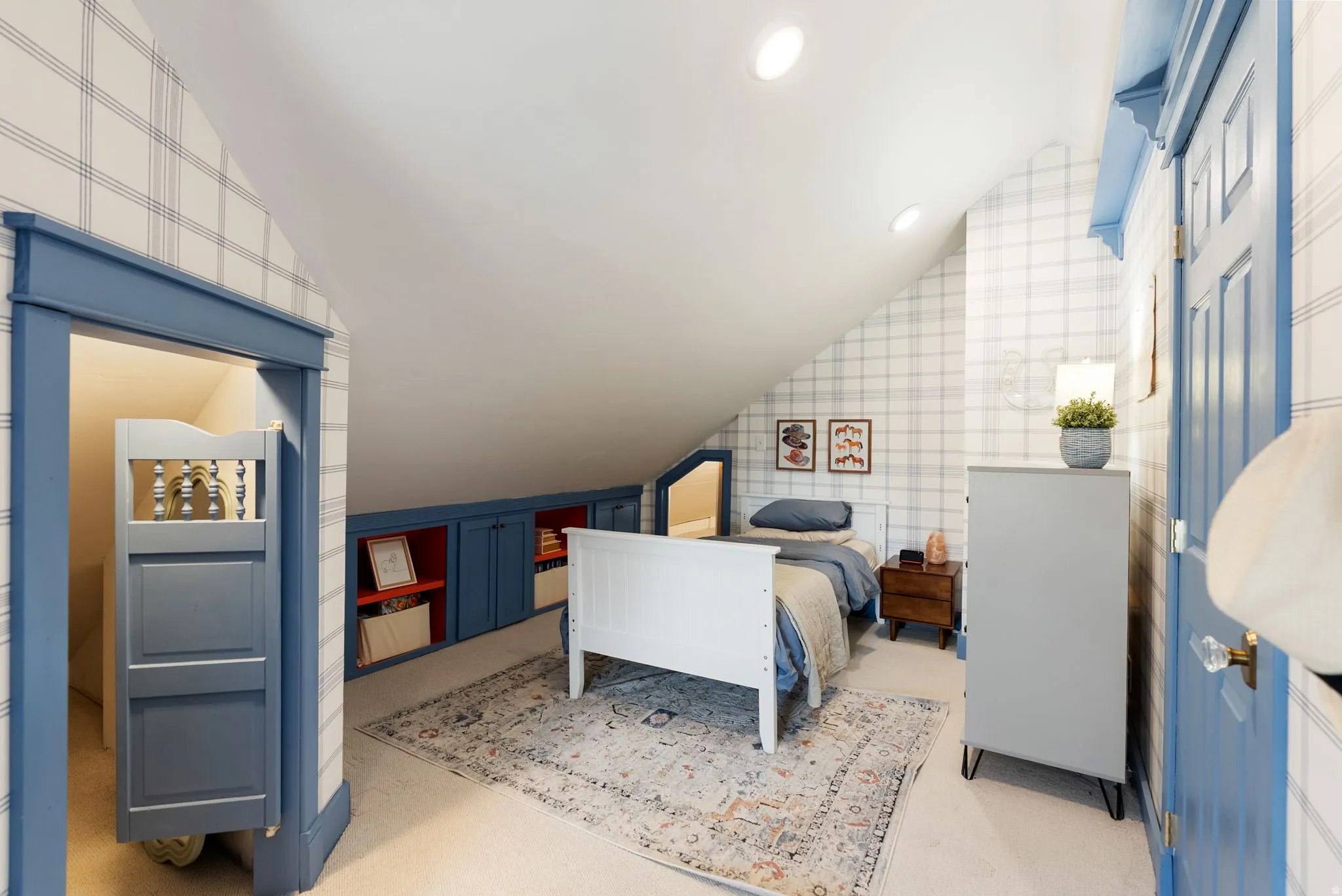 Bedroom featuring lofted ceiling, wallpapered walls, and recessed lighting