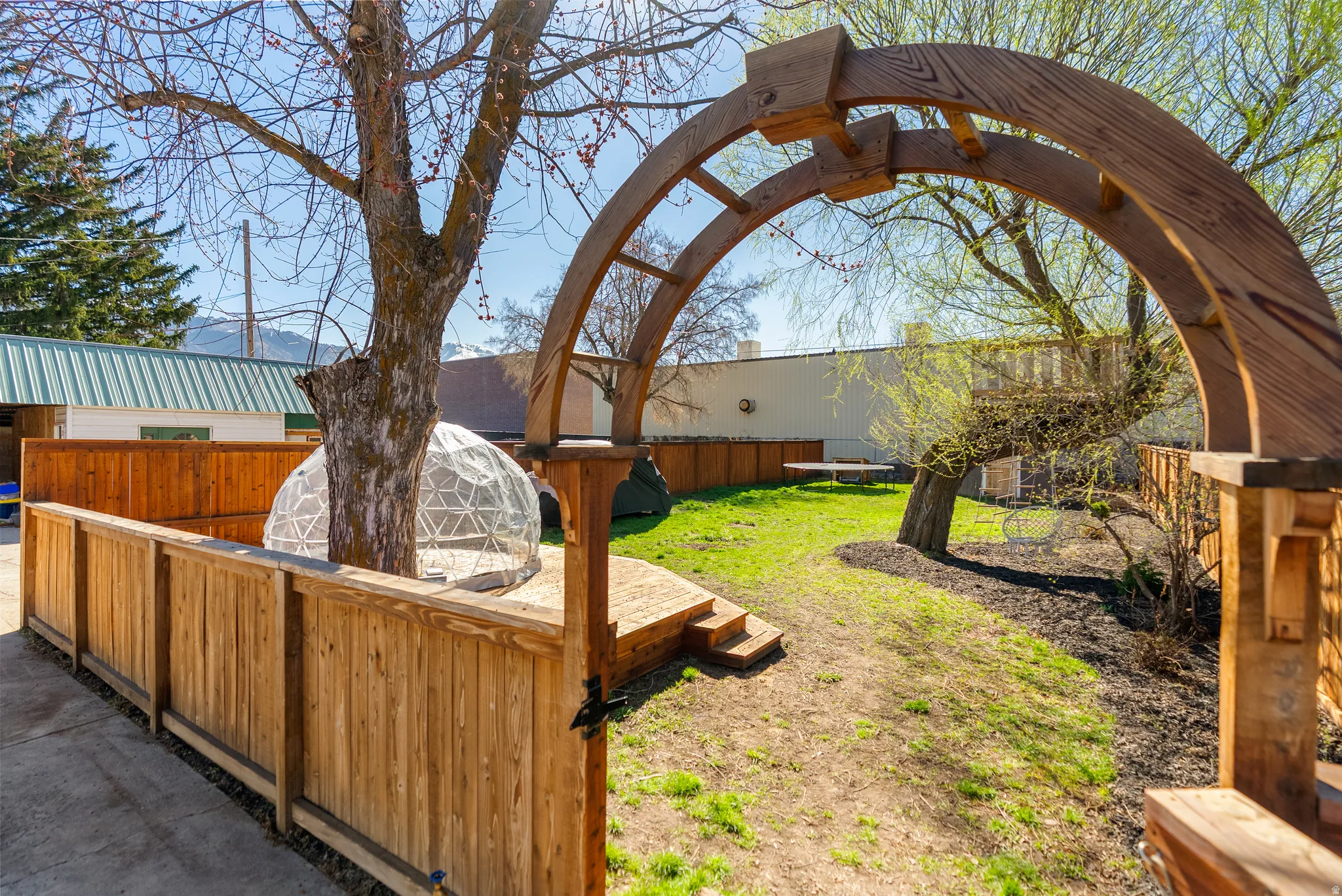 Fenced backyard with an outdoor structure