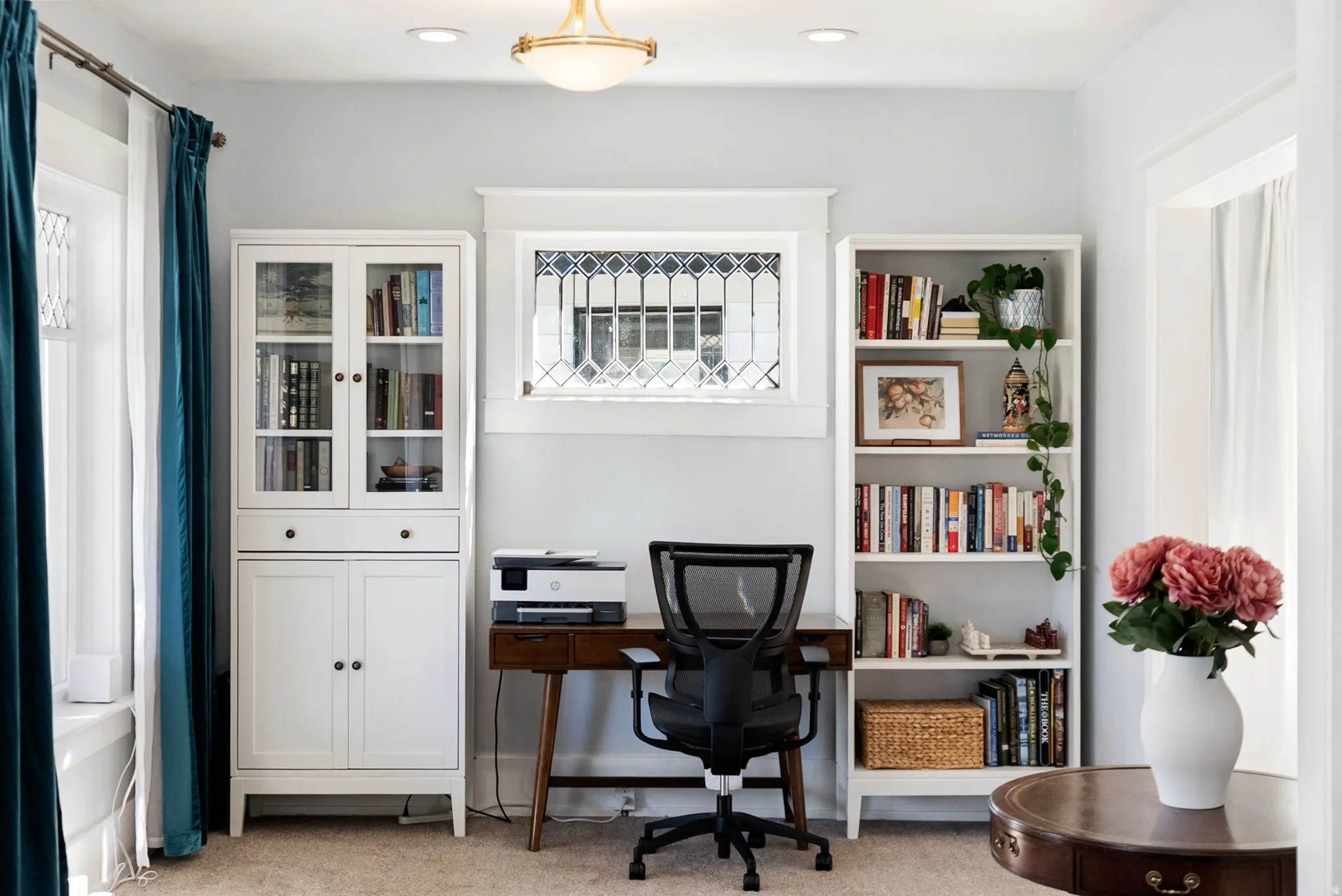 Office area featuring light carpet