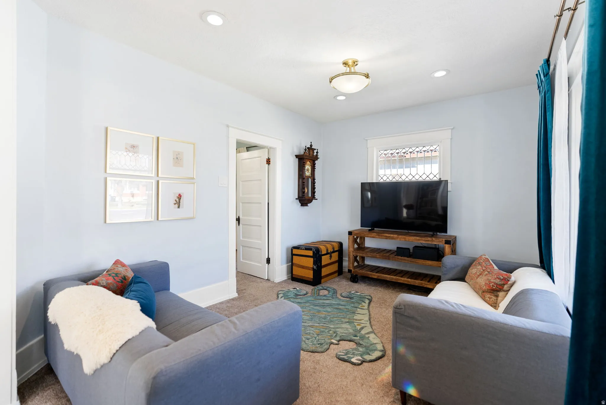 Carpeted living room with recessed lighting and baseboards