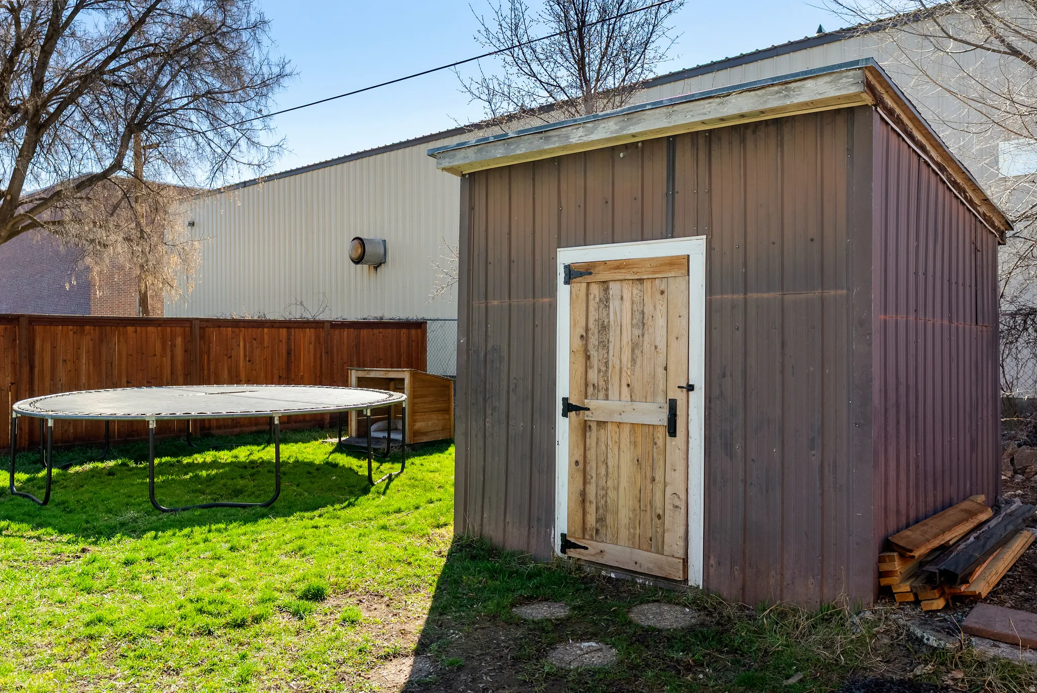 View of shed with a trampoline