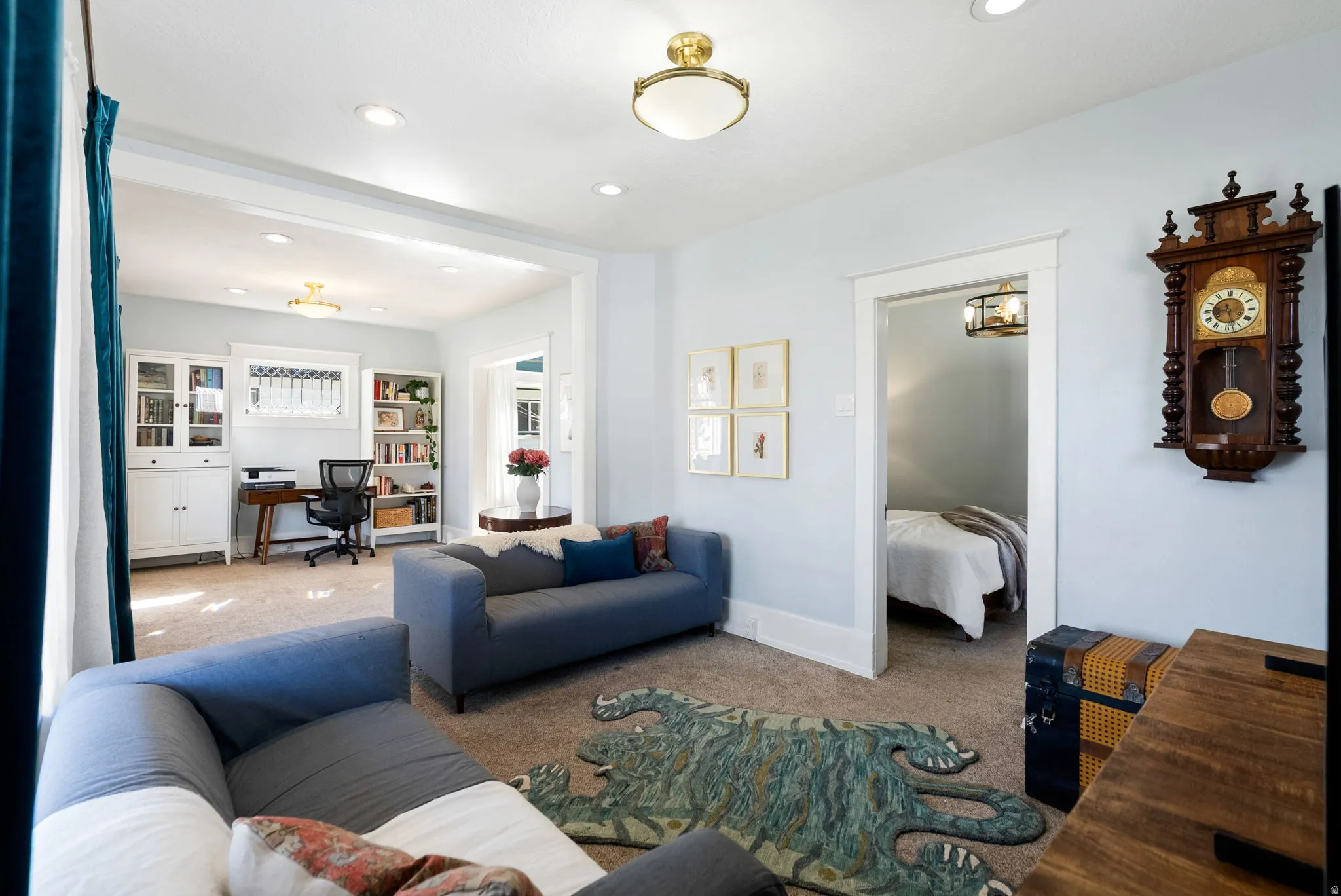 Living area with a desk, carpet floors, and recessed lighting