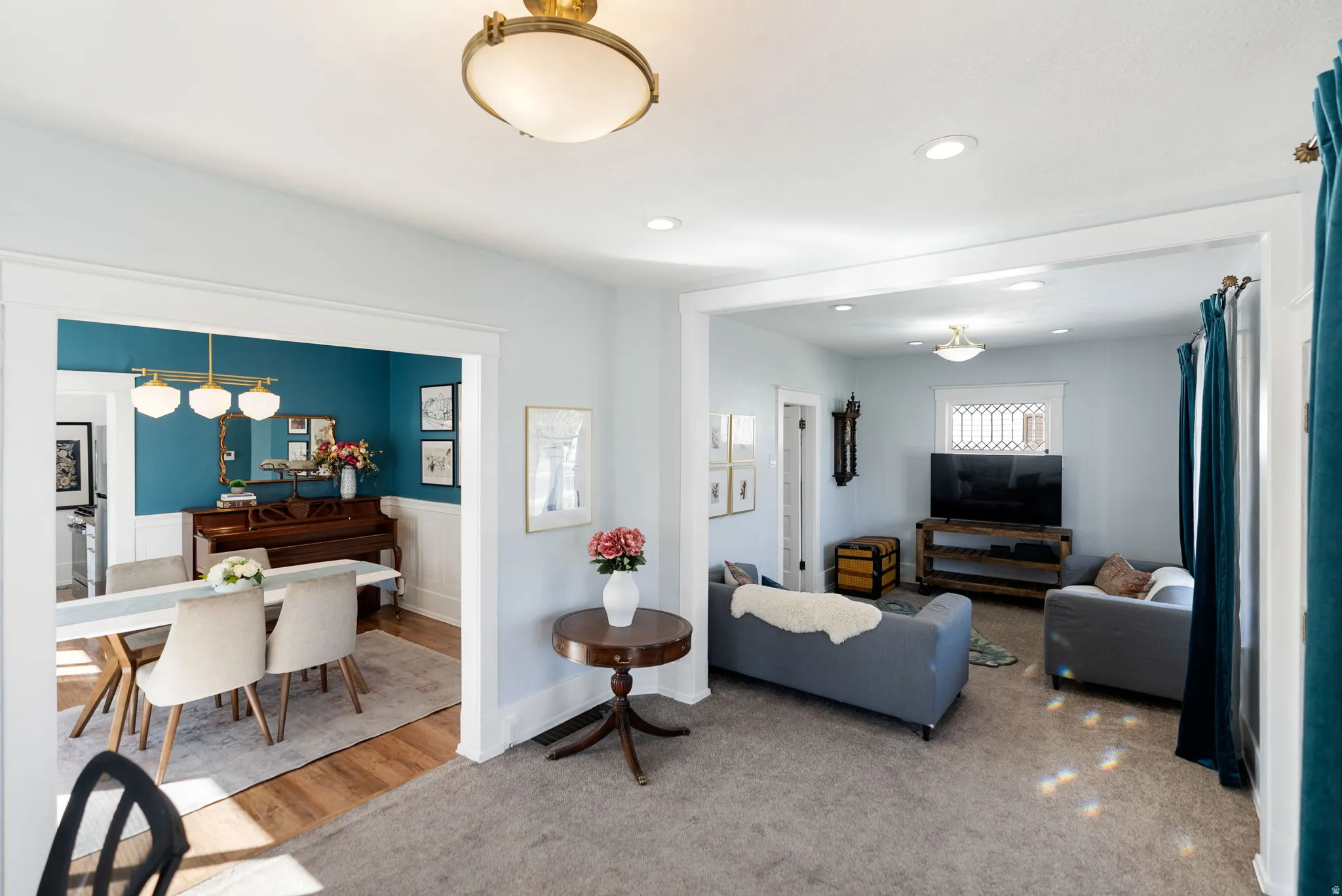 Living room featuring recessed lighting, a wainscoted wall, and wood finished floors