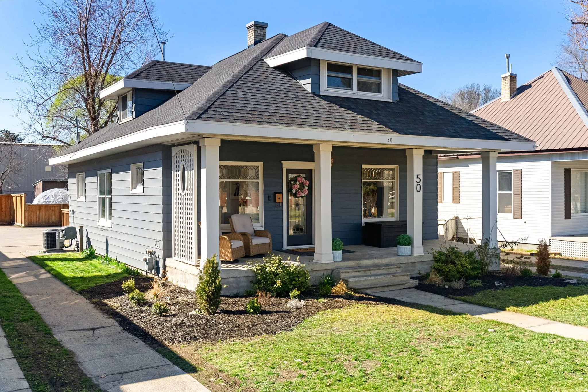 Bungalow with a porch, a chimney, and a shingled roof