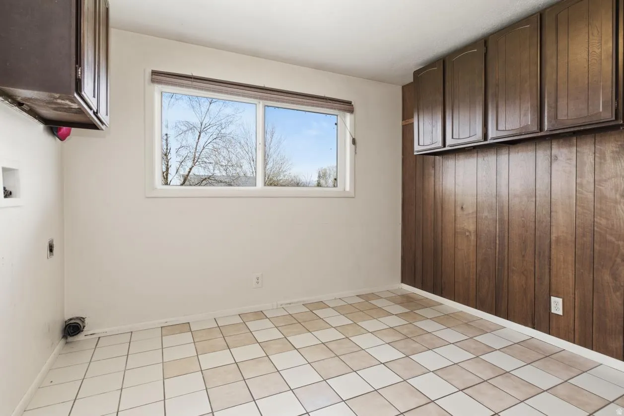 Laundry area featuring cabinet space, hookup for a washing machine, and electric dryer hookup