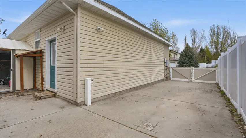 View of side of property featuring a gate