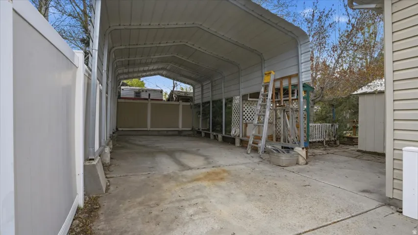 View of parking featuring a carport
